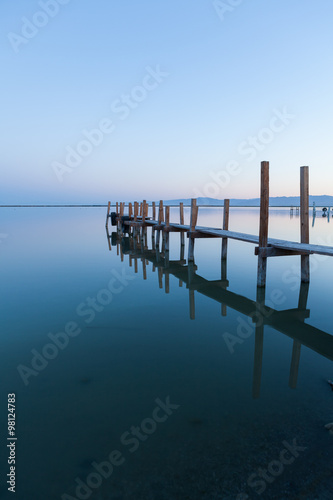 An old wooden fishing pier in the morning.