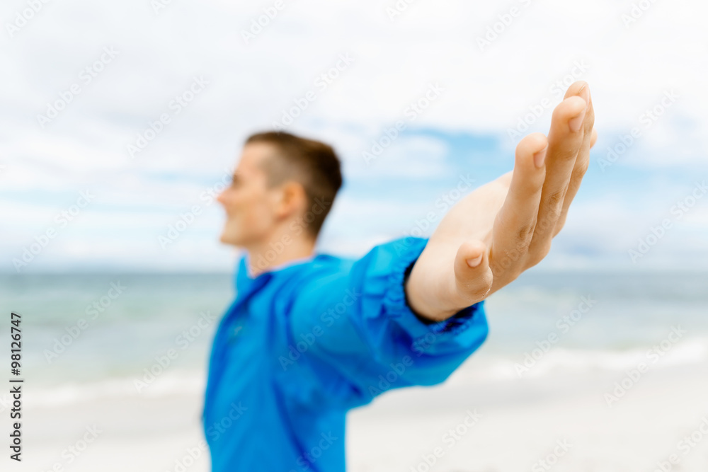 Young man in sport wear with outstretched arms