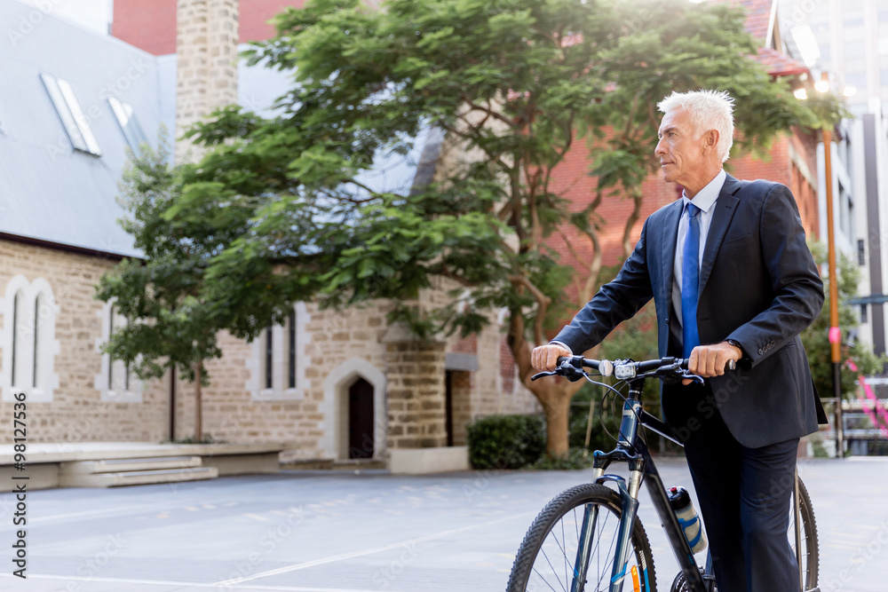 Obraz premium Successful businessman riding bicycle
