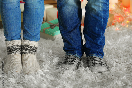 Legs in colorful socks on white carpet background