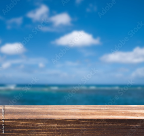 Wood table top with blur sea background