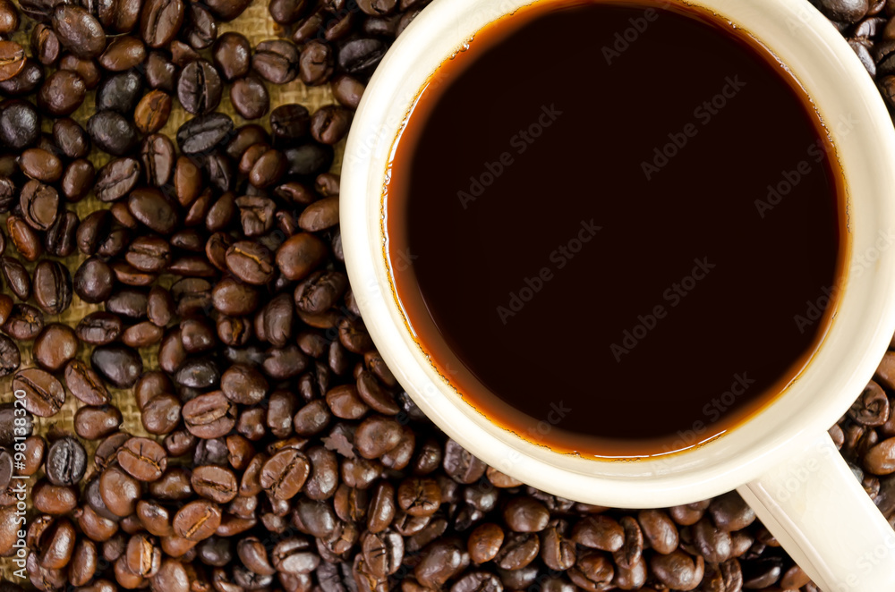 Fototapeta premium Dark coffee cup on coffee beans