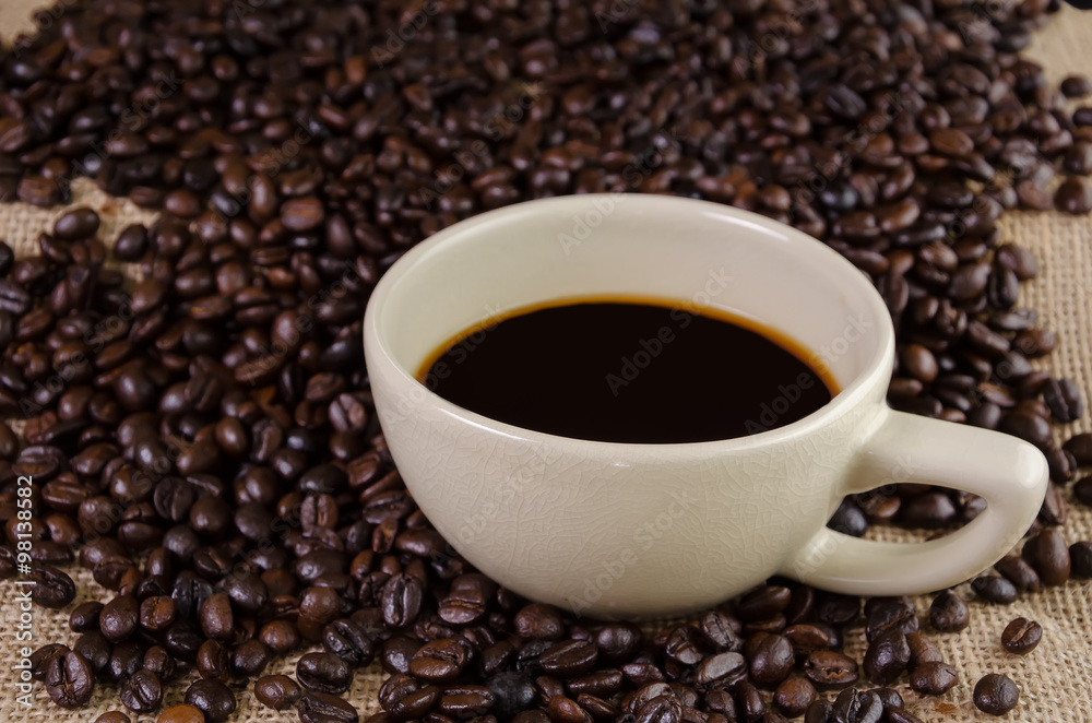 Dark coffee cup and roast coffee beans Dark coffee cup and roast coffee beans