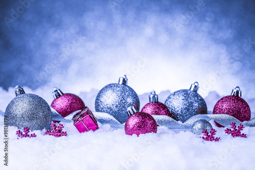 christmas ornament in snow on glitter background