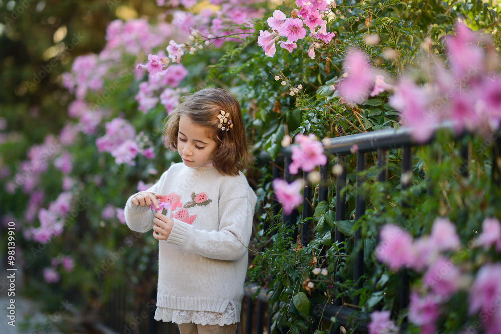 Little girl playing in a city park in autumn Little girl playing in a city park in autumn