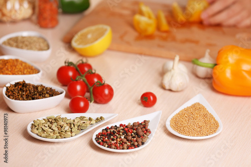 Fototapeta Naklejka Na Ścianę i Meble -  Variety of spices in ceramic containers on the kitchen table