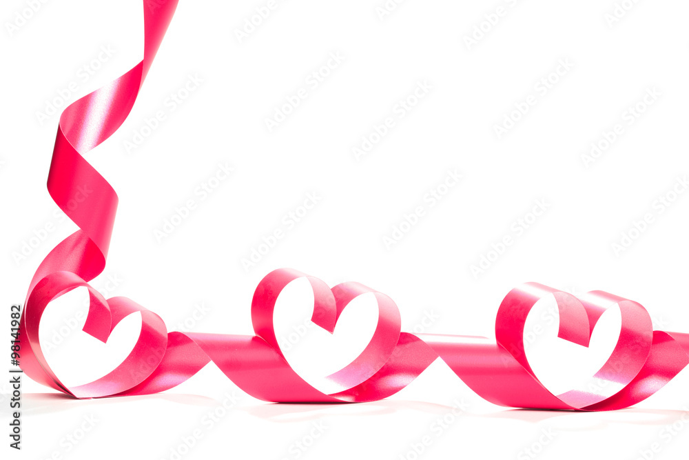 Ribbons shaped as hearts on white