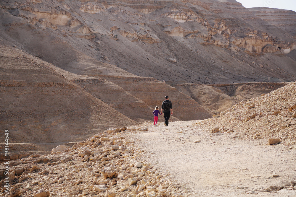 father and daughter traveling in the desert