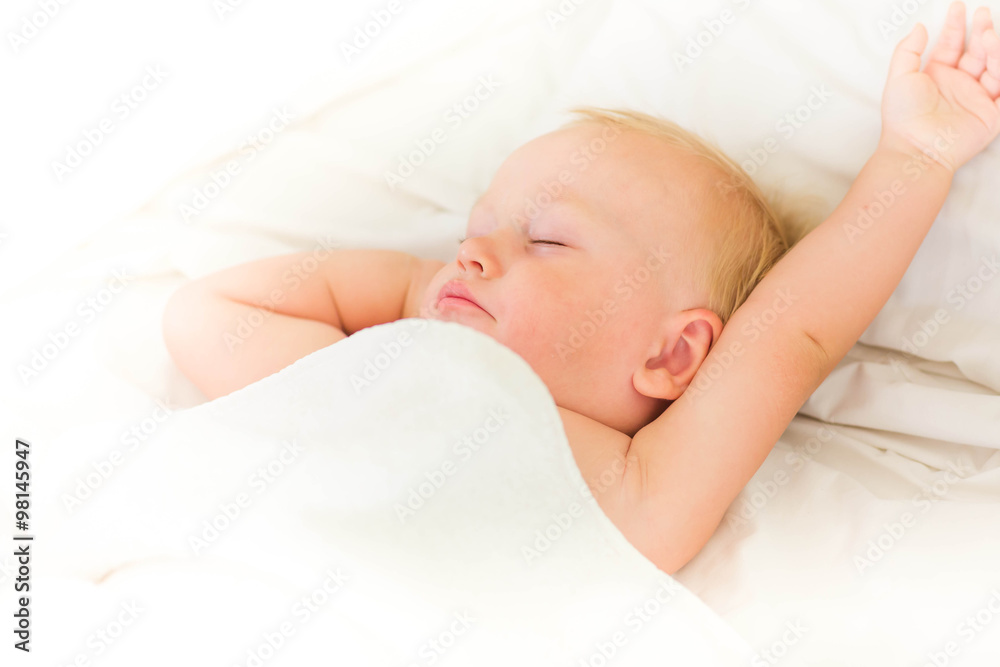 Peaceful baby lying on a bed sleeping Peaceful baby lying on a bed sleeping