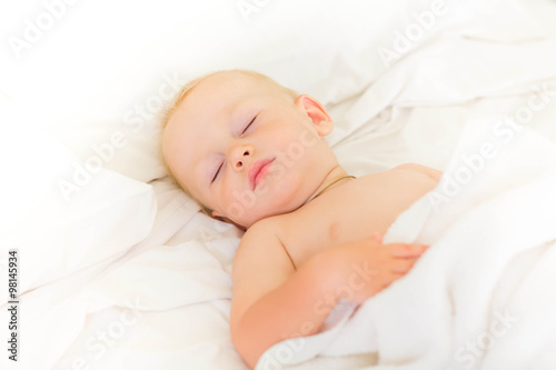 Peaceful baby lying on a bed sleeping