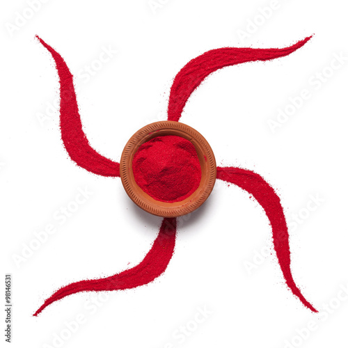 Top view close up of red color swastik rangoli symbol with clay pot isolated on white background.