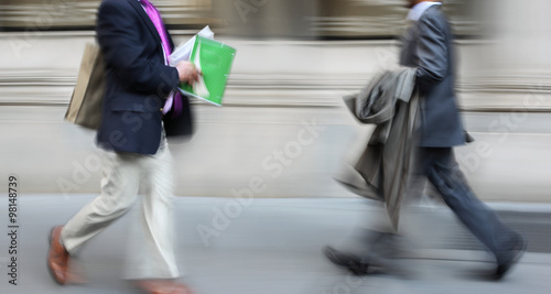 motion blurred business people walking on the street