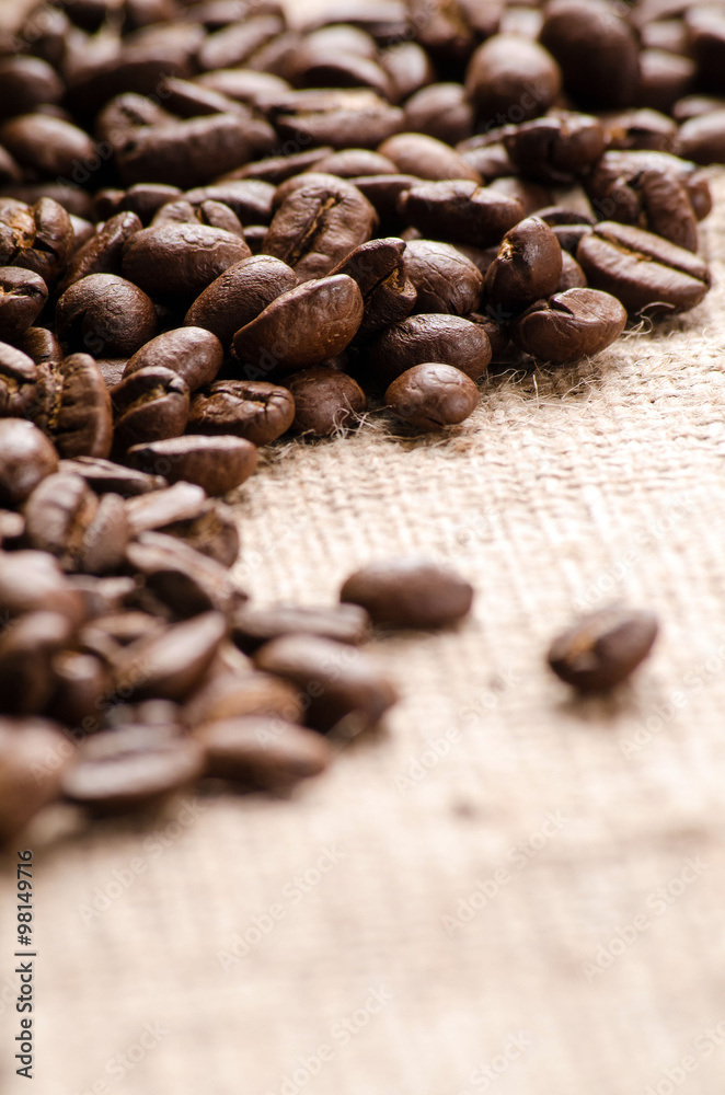 Coffee beans on table on sackcloth close up Coffee beans on table on sackcloth close up