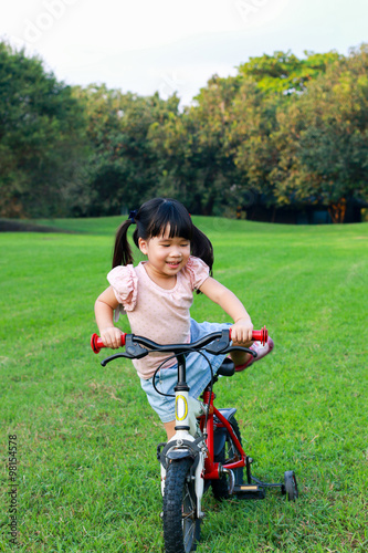 Cute Asian girl enjoy with bicycle