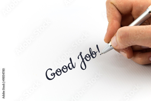 Hand writing "Good Job" on white sheet of paper.