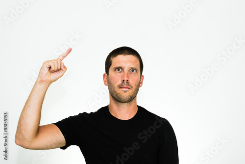 close-up of a concentrated young caucasian man raising a finger - isolated on white background