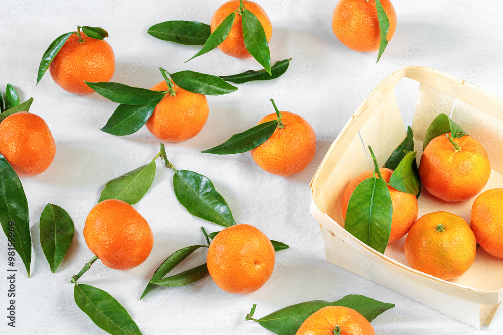 Tangerines on white tablecloth Tangerines on white tablecloth
