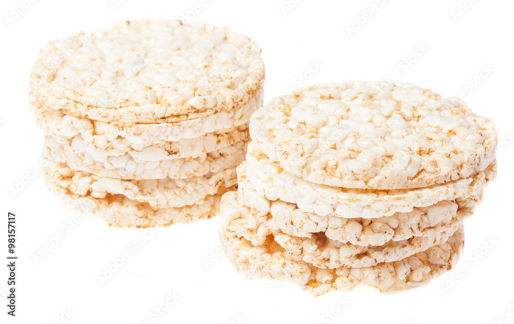two piles of puffed rice snack on a white background two piles of puffed rice snack on a white background