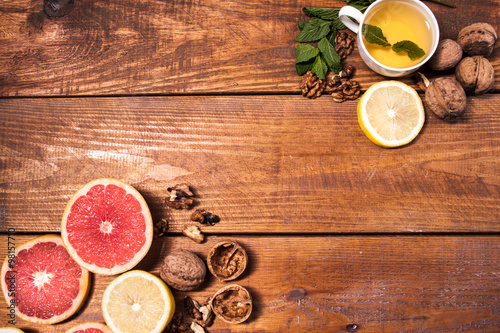 Lemon and walnut on a wooden surface close up