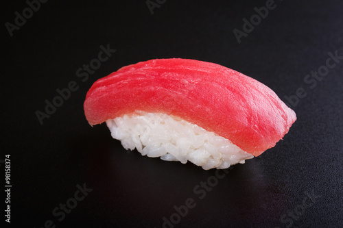 Nigiri sushi with tuna on black background