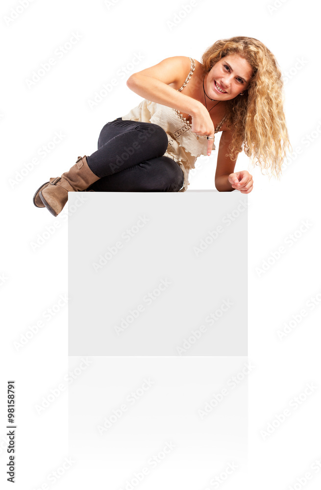 Woman sitting on blank empty box, pointing down at copy space. Woman sitting on blank empty box, pointing down at copy space.