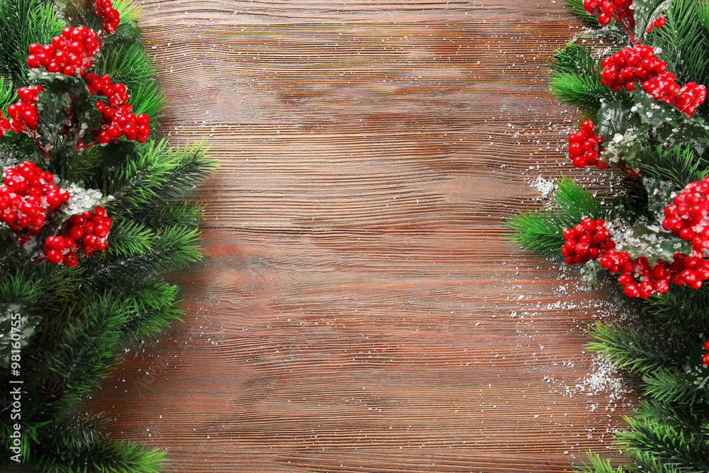 Christmas fir tree branches with rowan on wooden table Christmas fir tree branches with rowan on wooden table