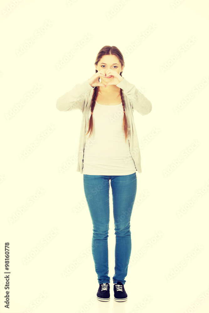 Teenager making heart shape with hands. Teenager making heart shape with hands.