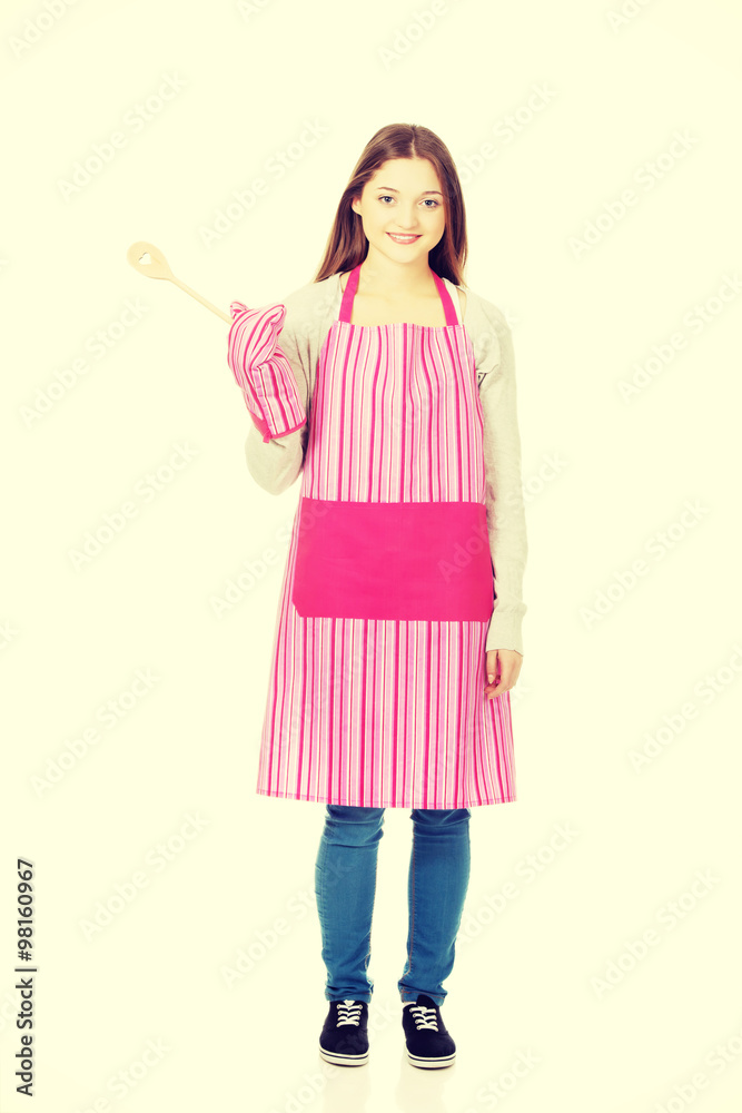 Happy teen woman wearing kitchen apron. Happy teen woman wearing kitchen apron.