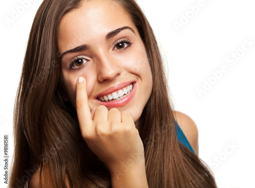 young woman pointing her eye on white background