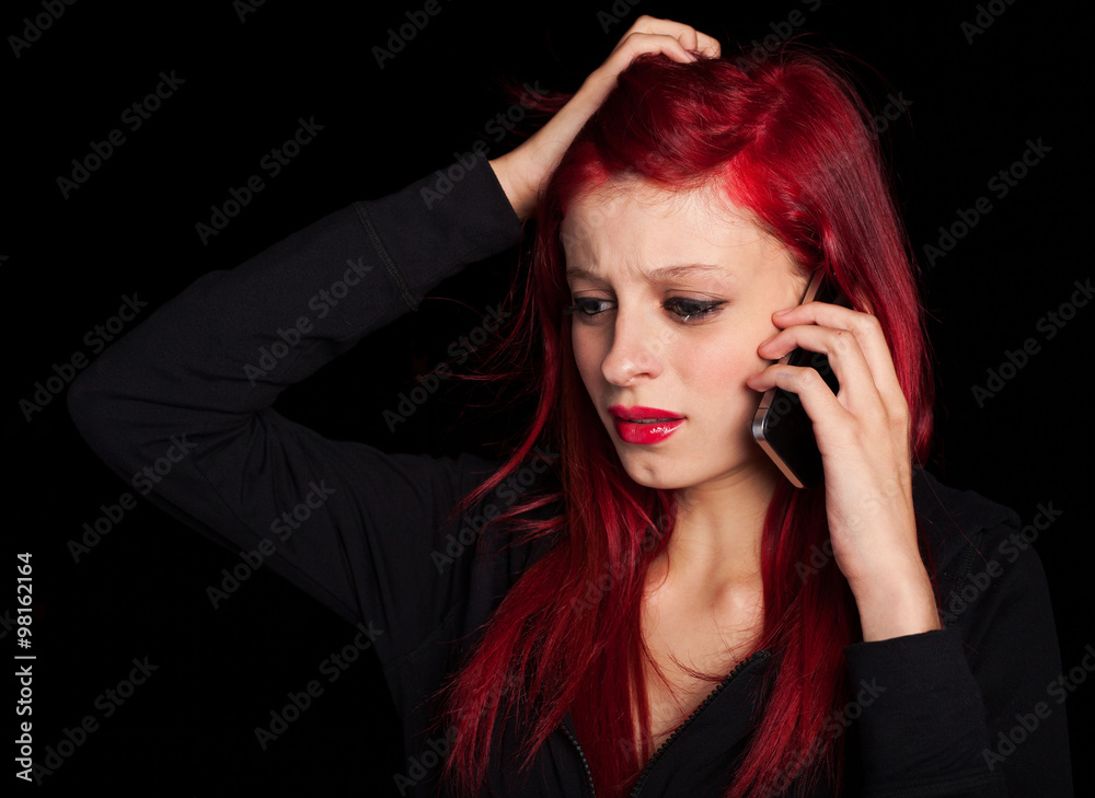 young woman talking on mobile and crying at night young woman talking on mobile and crying at night