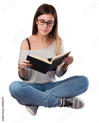 young woman reading a book sitting on the floor