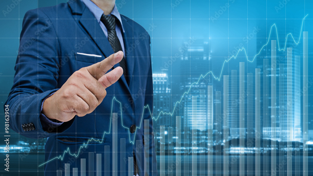 business man touch visual graph on screen with night city backgr business man touch visual graph on screen with night city backgr