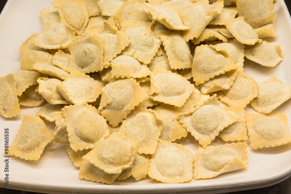 Platter of fresh homemade uncooked pasta ravioli