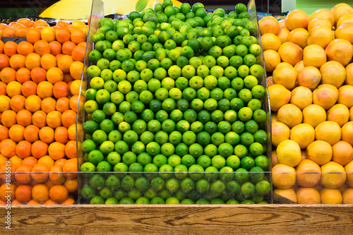 Produce market of fresh limes, grapefruit and oranges on display