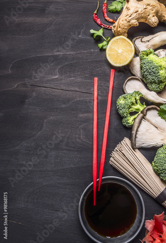 Healthy foods, cooking  concept Japanese buckwheat noodles with ginger, oyster mushrooms, soy sauce on wooden rustic background top view border, place for text  photo