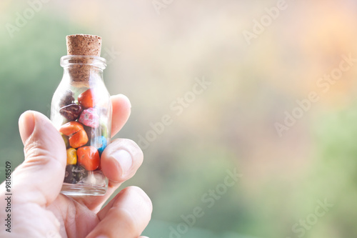 holding a bottle of pebbles candies
