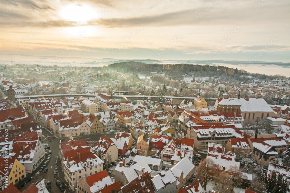 Winter panorama of medieval town within fortified wall. Top view from 
