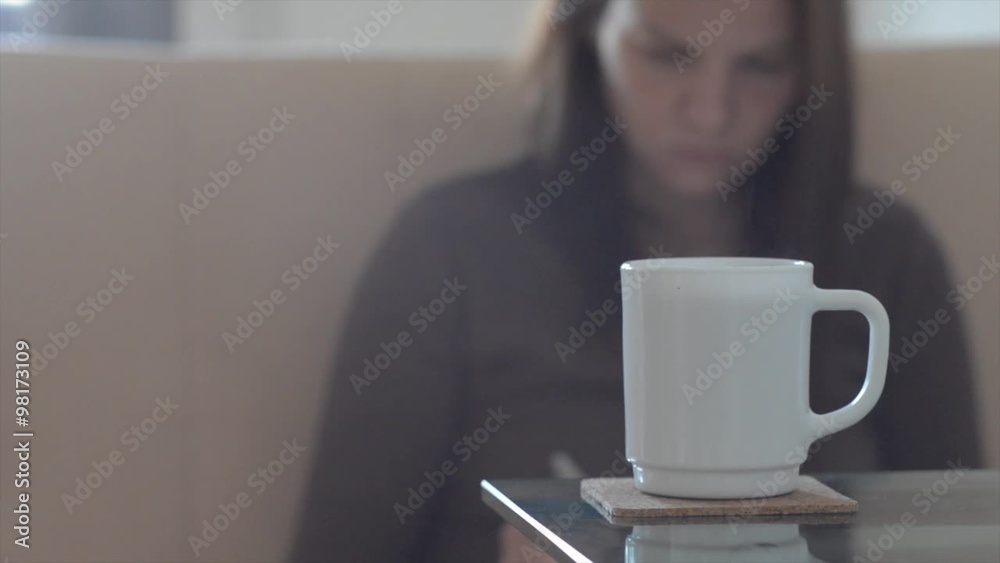 Girl drinking coffee tea and working with the tablet reading a book. At home. Girl drinking coffee tea and working with the tablet reading a book. At home.