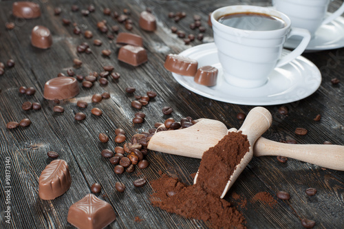 coffee cup background with coffee beans and chocolate candies