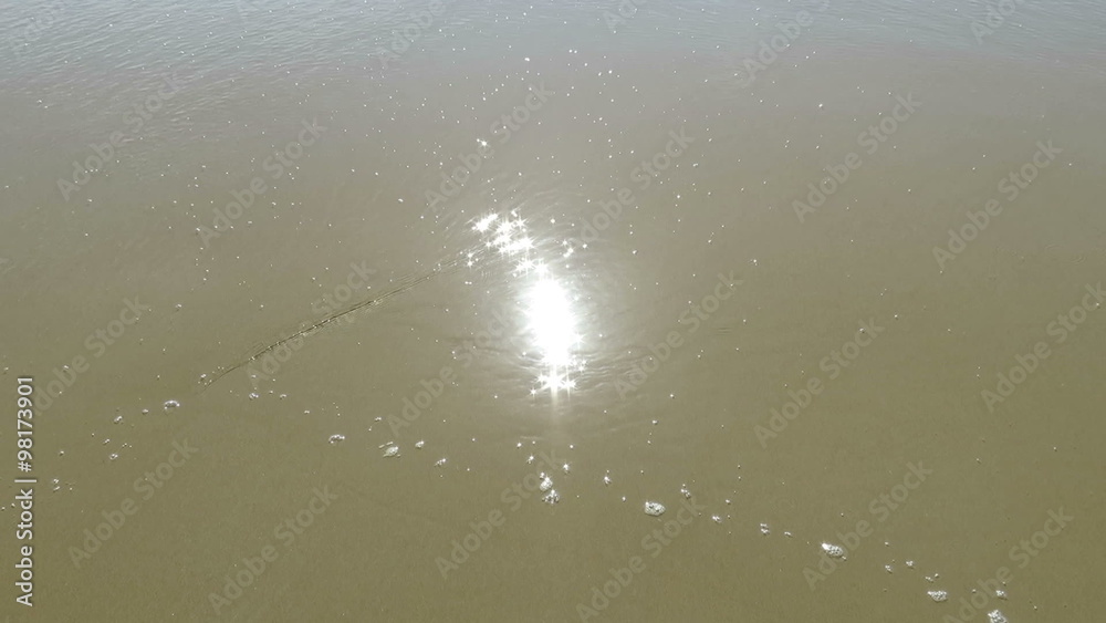 sun reflected sparkling on brown sand ground and water waves of tide beach ocean seashore in Spain Europe
sun reflected sparkling on brown sand ground and water waves of tide beach ocean seashore in Spain Europe