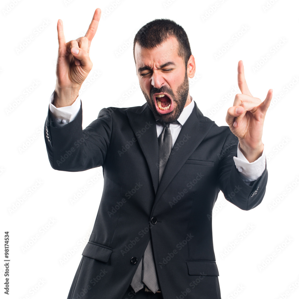 Businessman making horn gesture Businessman making horn gesture