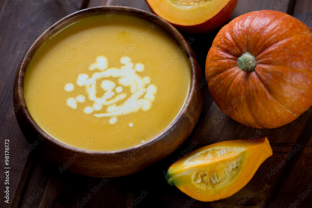 Close-up of pumpkin soup with cream topping, selective focus Close-up of pumpkin soup with cream topping, selective focus
