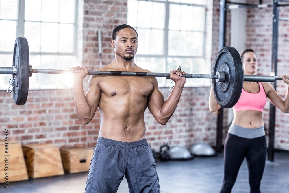 Fit couple lifting weight together Fit couple lifting weight together