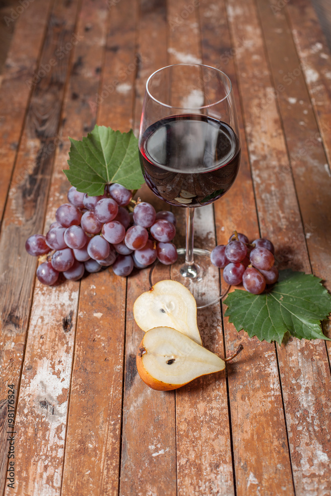 Glass of red wine, honeycomb, grapes on a wooden background. Selective focus. Glass of red wine, honeycomb, grapes on a wooden background. Selective focus.