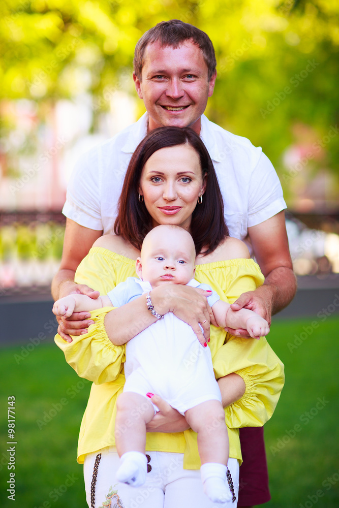 Fototapeta premium Portrait of a father, mother and baby