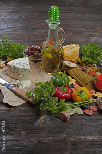 Fototapeta Naklejka Na Ścianę i Meble -  Italian cuisine. Vegetables, oil, spices and pasta on the table