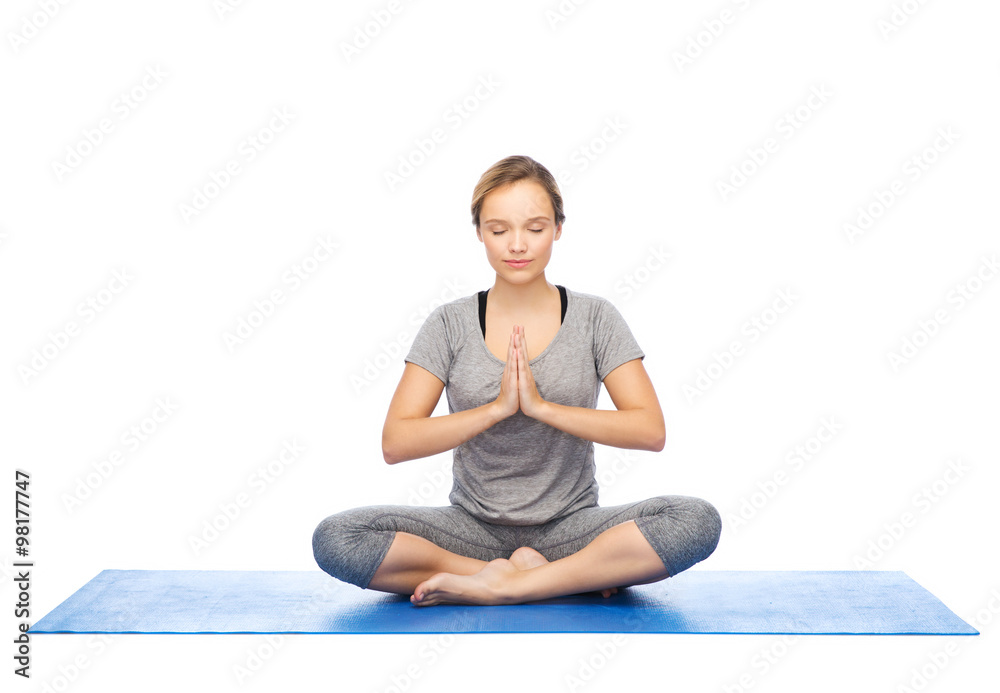 woman making yoga meditation in lotus pose on mat woman making yoga meditation in lotus pose on mat
