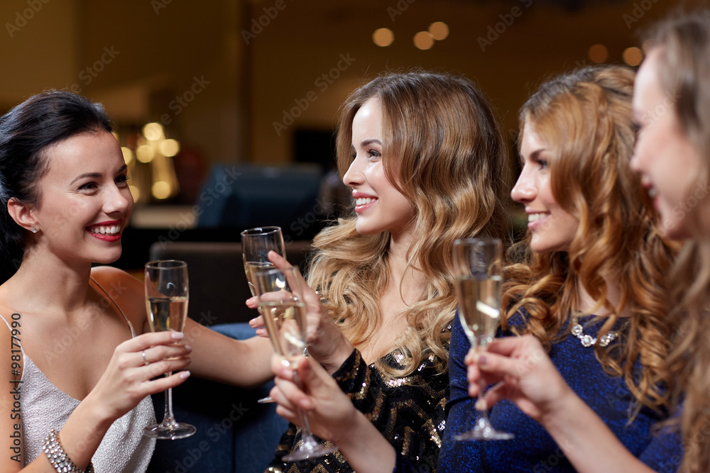 happy women with champagne glasses at night club