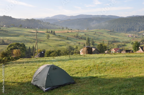 Tourist tent in camp among meadow in the mountain