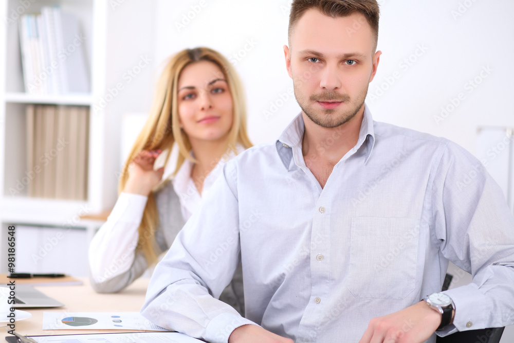 Successful businesspeople working at meeting in office. Businessman looking at camera. Start up business concept. Successful businesspeople working at meeting in office. Businessman looking at camera. Start up business concept.